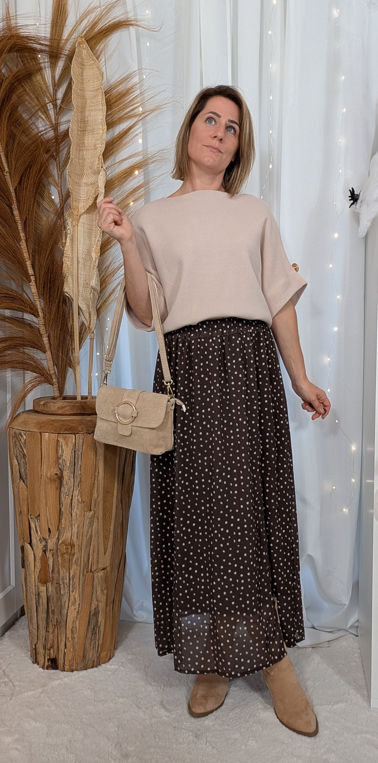 Pull avec manches à boutons dorés